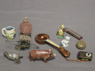 A carved stone figure of a pig 3", a tortoiseshell and mother of pearl model banjo 6" and other various curios etc