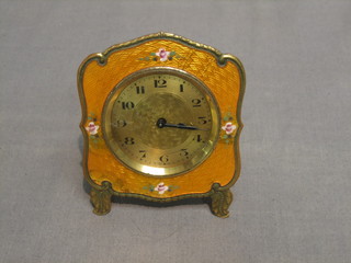 An Art Deco 1920's travelling clock contained in a yellow enamelled and floral patterned case 3"