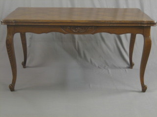 A French oak drawleaf dining table raised on cabriole supports 58"