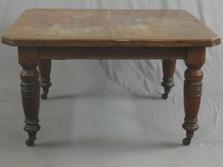 A Victorian mahogany extending dining table with 1 extra leaf, raised on turned supports 51"