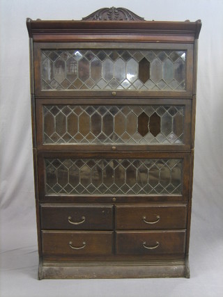 An oak and mahogany 4 tier Globe Wernicke bookcase the upper section with three-quarter gallery enclosed by lead glazed doors, the base fitted 4 short drawers 34"