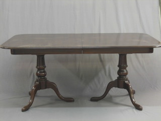 A Georgian mahogany twin pillar extending dining table, with 2 extra leaves, 66"
