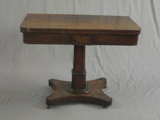 A William IV rosewood D shaped card table, raised on a square column with triform base 36"