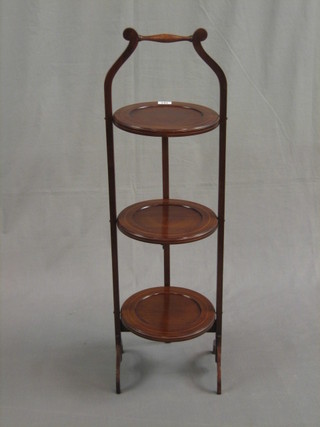 An Edwardian inlaid mahogany circular 3 tier folding cake stand