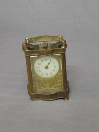 A 19th Century French carriage clock contained in a gilt metal case (requires attention)
