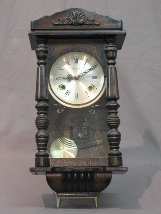 A striking wall clock with silvered dial and Roman numerals, the dial marked Holly contained in a mahogany case