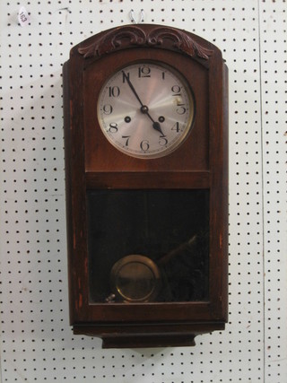 A 1930's striking wall clock with silvered dial and Arabic numerals, contained in an oak case