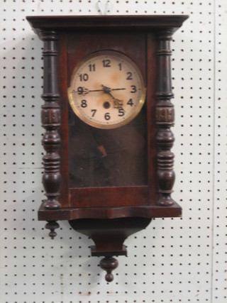A Continental wall clock with paper dial and Arabic numerals contained in a mahogany framed case