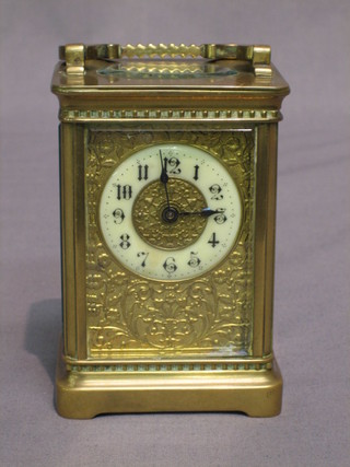 A 19th Century French 8 day carriage clock with porcelain dial and Arabic numerals contained in a gilt metal case (with replacement platform)