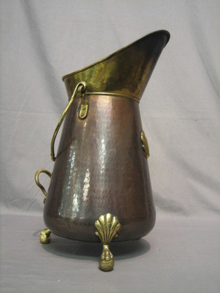 A reproduction copper and brass coal scuttle