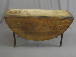 A bleached oak oval drop flap gateleg dining table, raised on club supports 51"