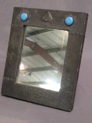 An Art Nouveau Liberty style square plate mirror contained in a planished pewter easel frame set cabouchon cut "turquoise" 13" x 11"