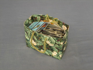 A small bag containing a collection of match box covers etc