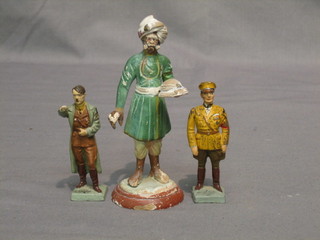 A WWII plastic figure of a standing Hitler and 1 other Goebel? 3" together with a terracotta figure of an Indian Bearer 5"