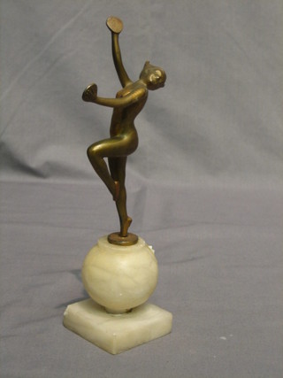 An Art Deco gilt painted spelter figure of a standing dancing girl with cymbals, raised on a marble base 9"