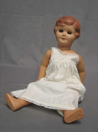 A Belgian Unica plastic doll, with open eyes and articulated body