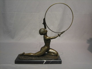 A reproduction Art Deco bronze figure of a lady with hoop, raised on a black marble base 13"