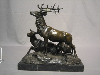A modern bronze figure group of a stag 15" raised on a black marble base