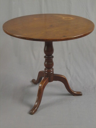 A 19th Century circular mahogany snap top tea table, raised on a turned tripod 28"