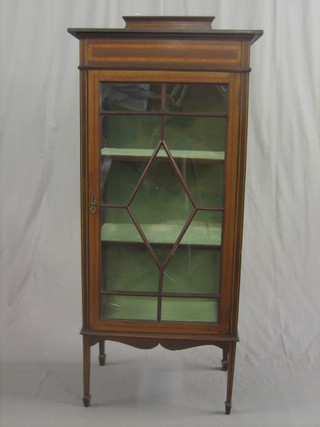 An Edwardian inlaid mahogany display cabinet, the interior fitted shelves enclosed by an astragal glazed panelled door, raised on square tapering supports 24"