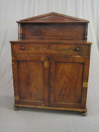 A William IV mahogany chiffonier with raised back fitted a shelf above 1 long drawer and cupboard enclosed by panelled doors, raised on bun feet 36"
