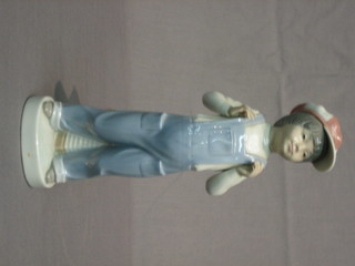 A Lladro figure - Boy Wearing Dungarees and a Hat 8"