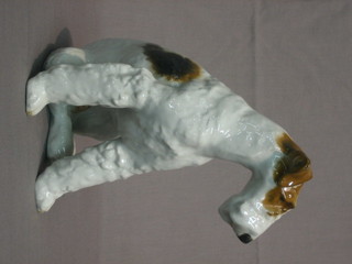 A Continental porcelain figure of a seated Airedale Terrier 9"