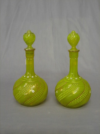 A pair of Vaseline glass club shaped decanters and stoppers 11"
