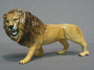 A Beswick figure of a walking lion 9"
