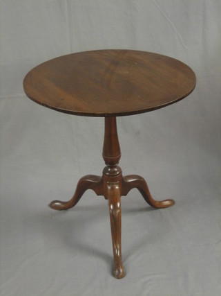 A 19th Century circular mahogany snap top tea table, raised on a turned column ending in a tripod base 24"