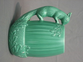 A Sylvac green glazed pottery jug, the handle in the form of a squirrel base marked 1115 Made in England (ears f and r) 8"