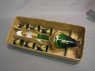 A 7 piece Bohemian green glass liqueur set comprising decanter and 6 beakers