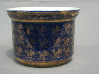 An Edwardian circular pottery jardiniere base, blue glazed and gilt banding 6"