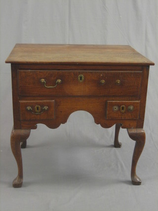 An 18th Century honey oak low boy, fitted 1 long and 2 short drawers, raised cabriole supports 28"