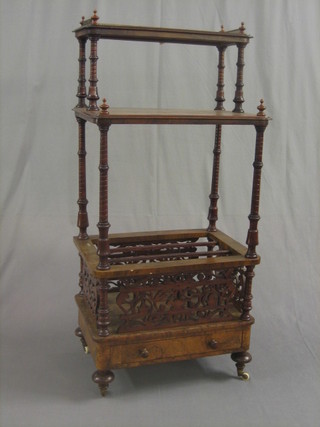 A Victorian figured walnut what-not Canterbury, the upper section with pierced brass three-quarter gallery, the base fitted a 3 section Canterbury with pierced panels above a drawer, raised on turned supports 23"