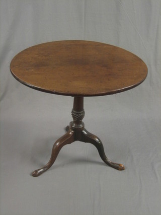 An 18th/19th Century circular snap top tea table, raised on a turned gun barrel column on a tripod base 30"