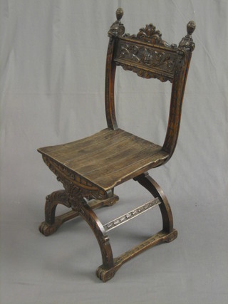 A 19th Century Italian carved oak bar back hall chair with solid seat, raised on X framed supports