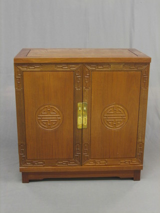 A 20th Century Padouk wood cutlery cabinet, the hinged lid revealing a fitted interior with cupboard beneath, complete with a canteen of various Eastern flatware 31"