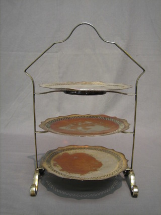 A circular silver plated 3 tier cake stand with pierced dishes