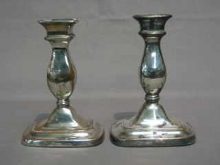 A pair of silver plated candlesticks 6"