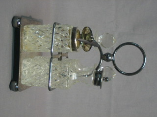 A silver plated 4 bottle cruet frame complete with bottles