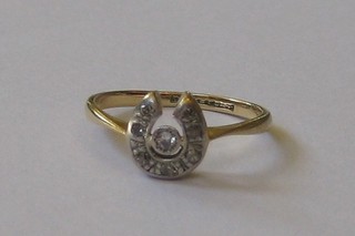 A lady's 18ct gold dress ring in the form of a horseshoe set 8 diamonds