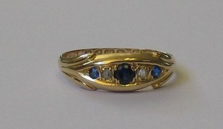 A lady's 18ct gold dress ring set 3 sapphires and 2 diamonds