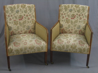 A pair of Edwardian inlaid mahogany armchairs, raised on square tapering supports