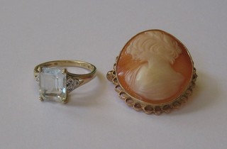 A lady's 9ct gold dress ring set a topaz and a shell carved cameo portrait brooch contained in a 9ct gold brooch mount