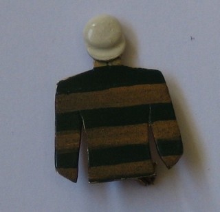 A 9ct gold and enamelled brooch in the form of a jockey