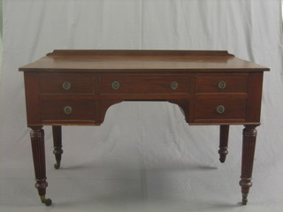 A William IV mahogany writing/dressing table fitted 1 long drawer flanked by 4 short drawers, raised on turned reeded supports 48"