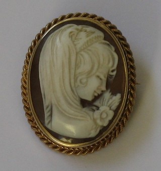 An oval shell carved cameo brooch set in a gold mount