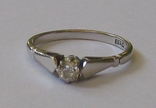 A 9ct white gold engagement/dress ring set a small solitaire diamond