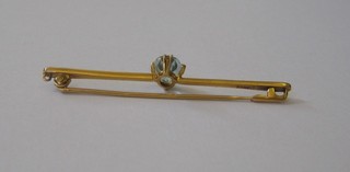 A 15ct gold bar brooch set an oval cut blue stone